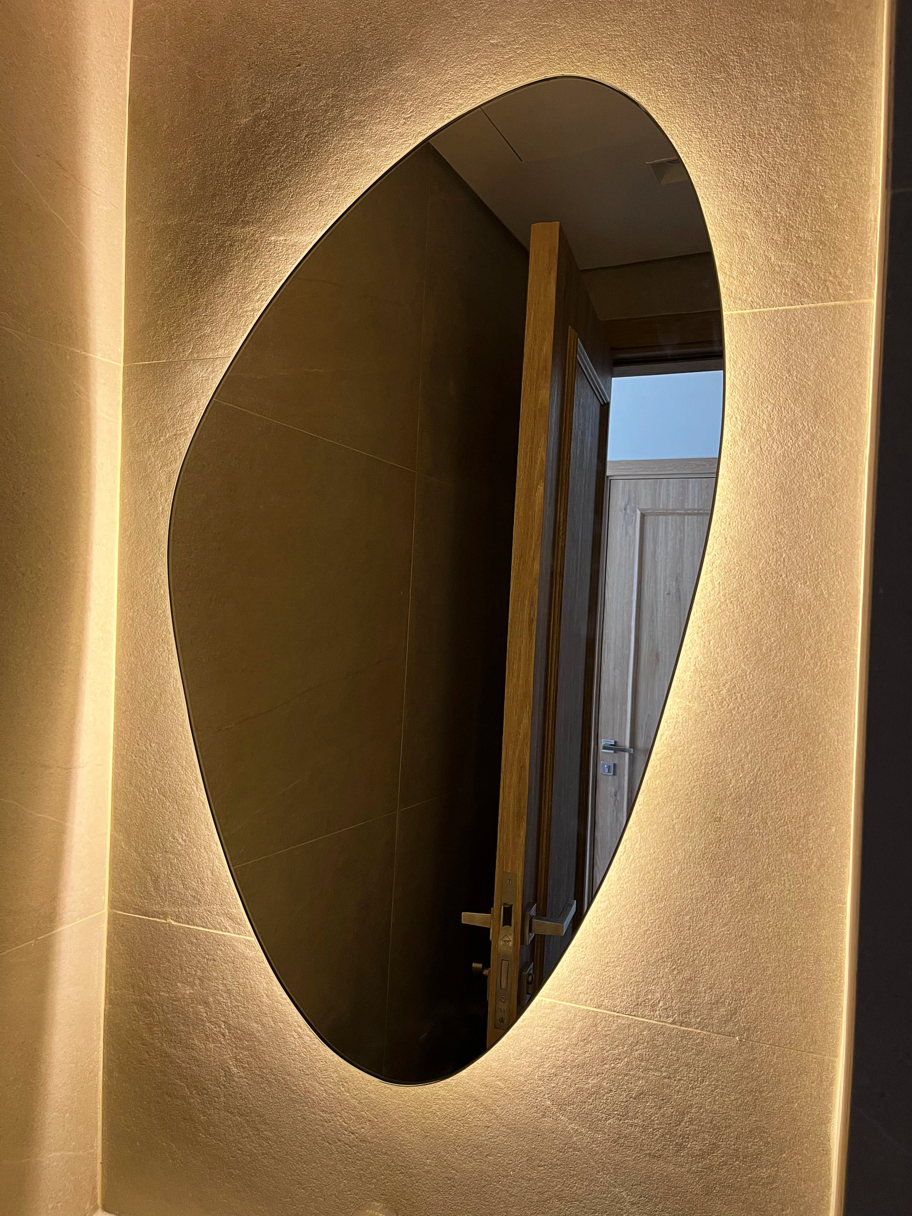 A large, elegant custom-framed mirror on a wall.